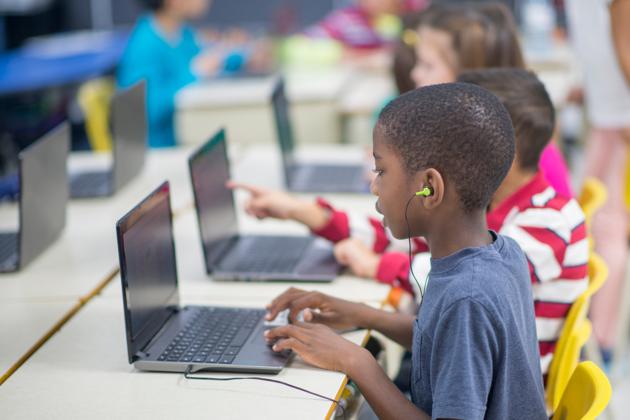 Children Learning How to Use Laptops